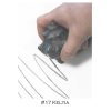 A person using a rubber stamp to make lines.