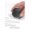 A person holding a scallop shell with two wires attached to it.