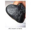 A black heart with a flower design on it.