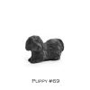 A black dog figurine sitting on top of a table.