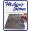 A person is painting the word love on a stone tablet.